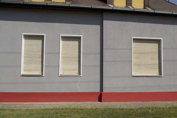 Windows with shutters in city gray wall pattern — Stock Photo, Image