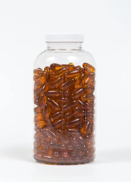 Fish oil capsules and container — Stock Photo, Image