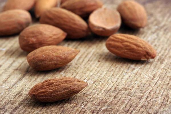 Almonds on wooden background — Stock Photo, Image