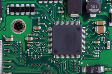 Green computer board with chips and components.