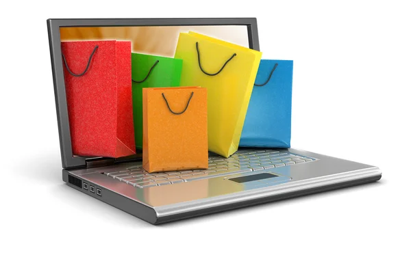 Laptop e sacos de compras — Fotografia de Stock