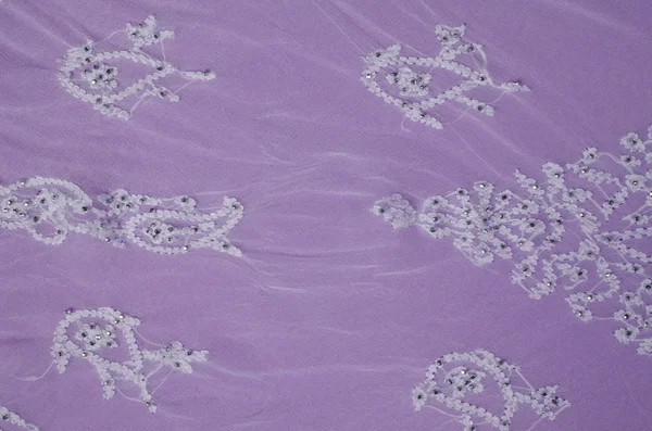Embroidery on purble fabric — Stock Photo, Image