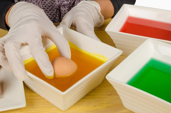 Dipping Easter eggs — Stock Photo, Image