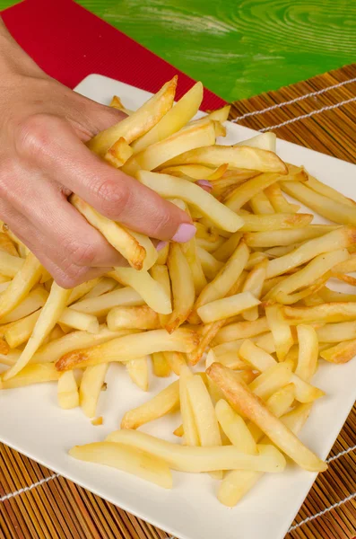 Grabbing french fries — Stock Photo, Image