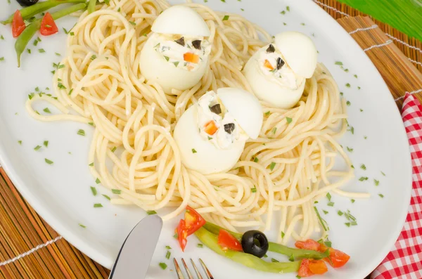 Eggs in a pasta nest — Stock Photo, Image