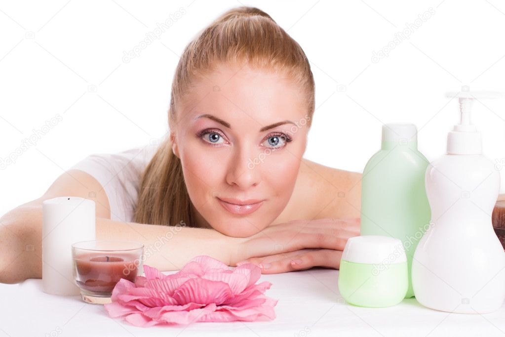 Beautiful woman face with skincare products