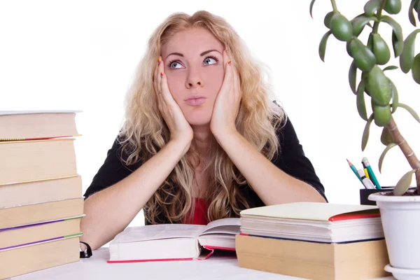 Oveworked student girl with pile of books isolated Royalty Free Stock Images