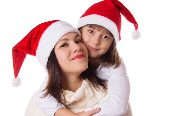 Happy mother and daughter hugging in Christmas hats — Stock Photo, Image