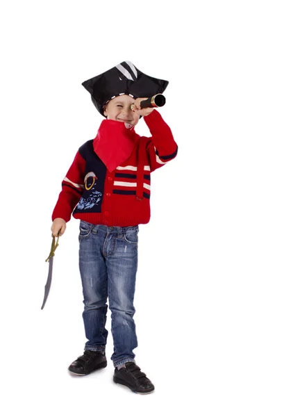 スパイグラスで見ている海賊のような服を着て少年 ストック写真