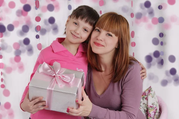 Loving mother and daughter with present — Stock Photo, Image