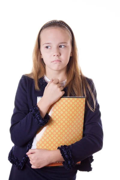 Upprörd skolflicka i uniform och böcker som tittar åt sidan — Stockfoto