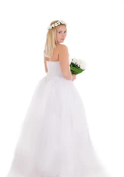 Blonde bride in wreath and bouquet standing backwards — Stock Photo, Image