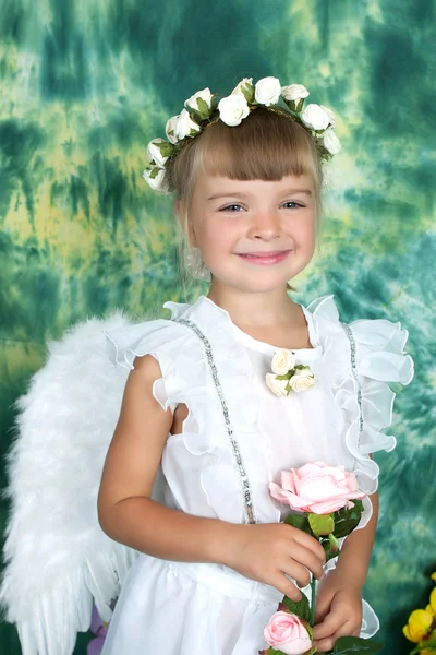 Cheerful girl with angel wings with a pink rose — Stock Photo, Image