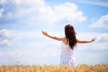 Woman in wheat field enjoying clipart