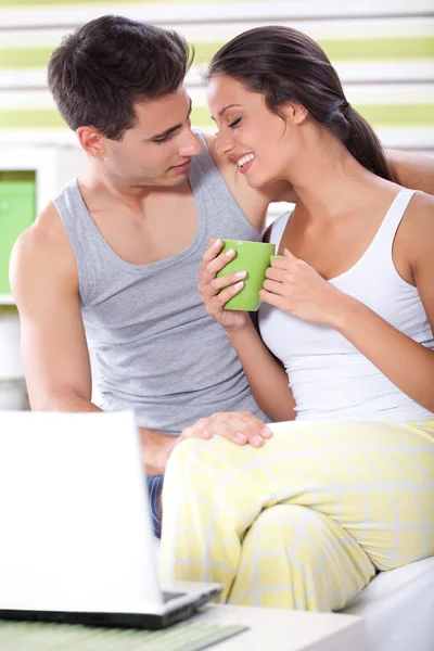 Couple using laptop in morning — Stock Photo, Image