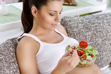 Beautiful pregnancy eating salad