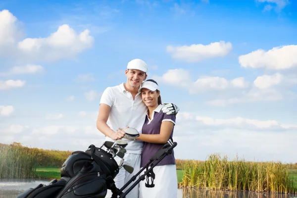 Pareja de golf con bolsa de golf — Foto de Stock