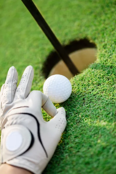 Golf ball on green grass next hole — Stock Photo, Image