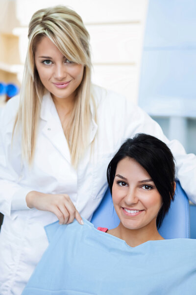 Cheerful dentists assistant with patient