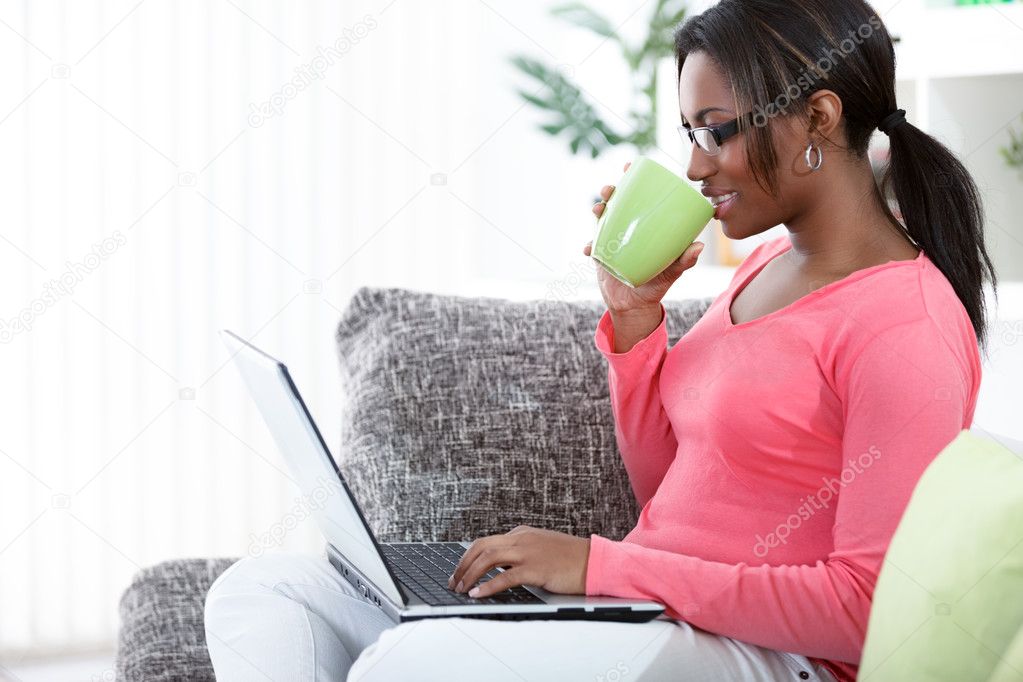 Woman in a sofa with laptop