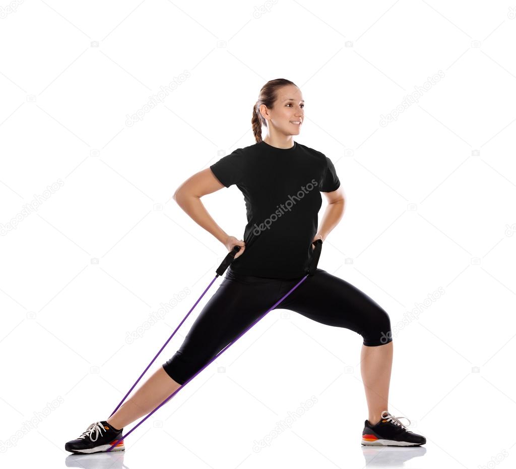 Woman doing exercise with resistance rubber