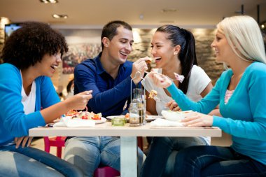 Group of teenagers enjoying in lunch clipart