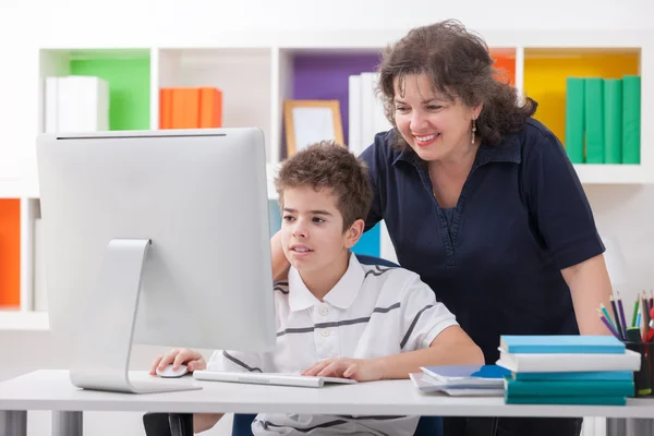 Vrouw met behulp van computer met zoon — Stockfoto