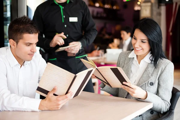 Smiling couple orders a meal — Stock Photo, Image