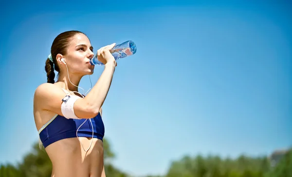 Woman drinking water after sport activities Stock Picture
