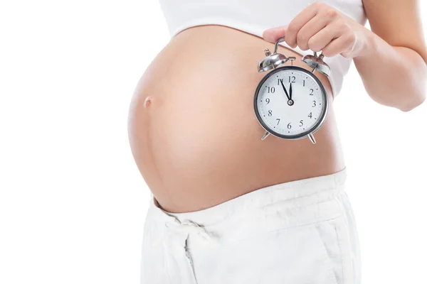 Kobieta w ciąży z zegarem — Zdjęcie stockowe