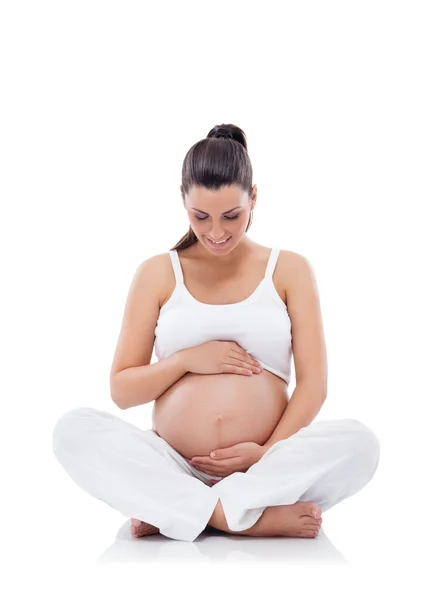 Pregnant woman sitting and practicing yoga — Stock Photo, Image