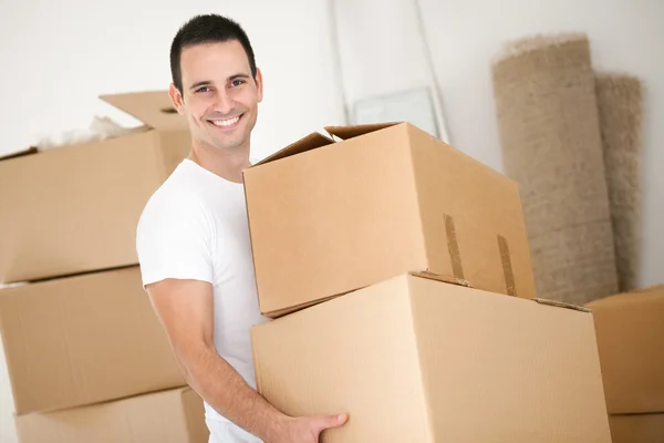 Cheerful man with cardboard box Stock Photo by ©luckybusiness 31883191