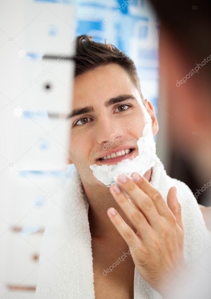 man putting shaving cream