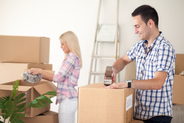 couple packing moving boxes