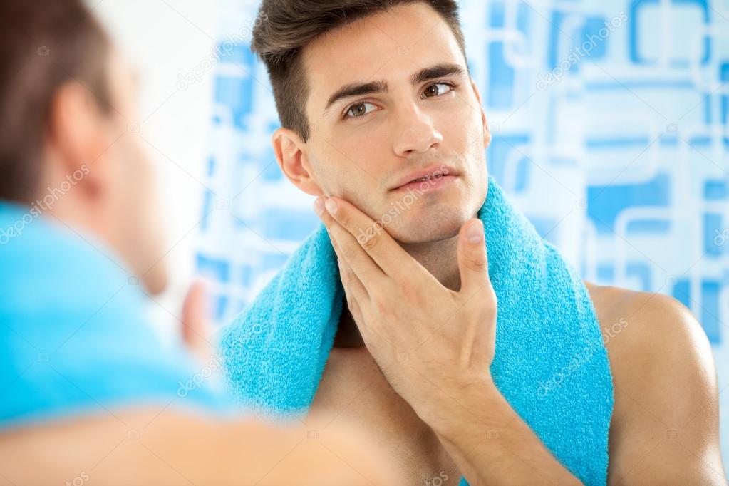 Man touching his face after shaving — Stock Photo © luckybusiness 32749383