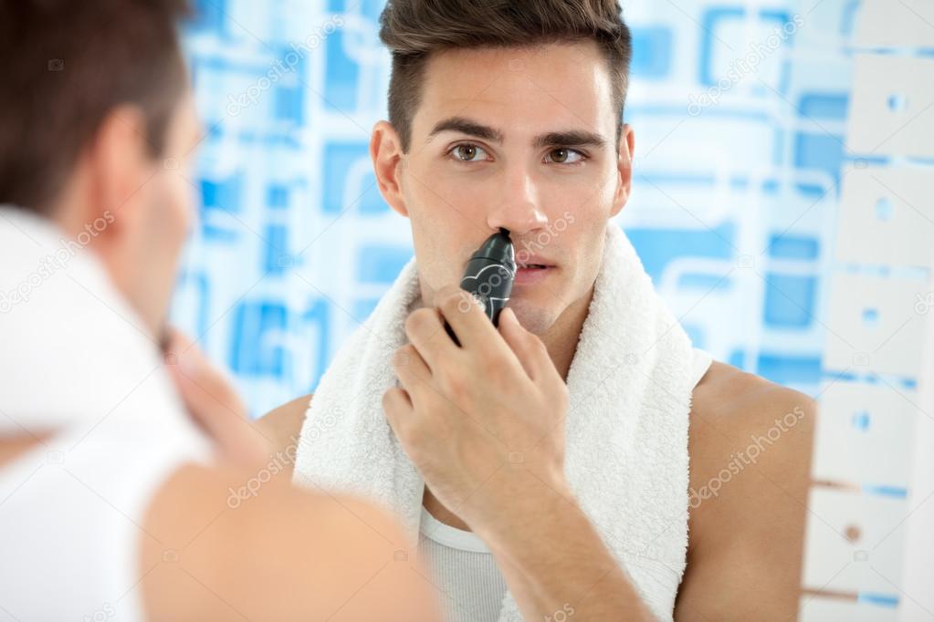 man remove hair from his nose