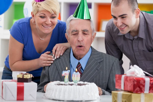 Family together blowing in the candles — Stock Photo, Image