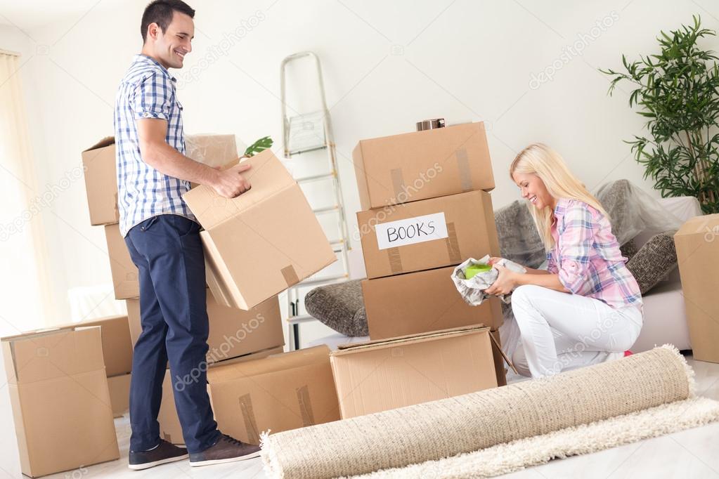 couple unpack moving boxes.