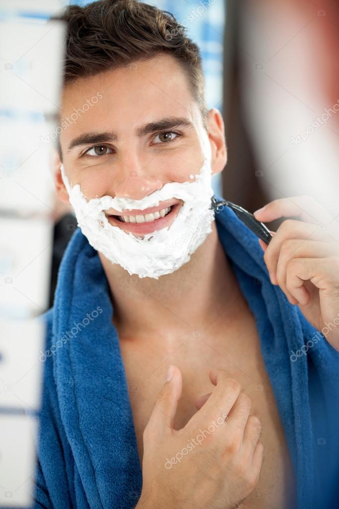 smiling handsome shaving man