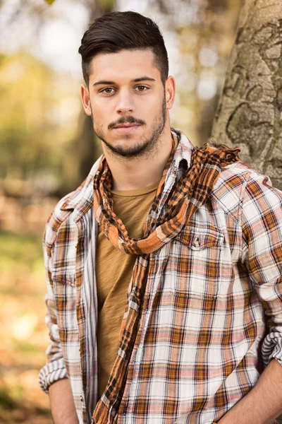 Young man in a checkered shirt — Stock Photo, Image