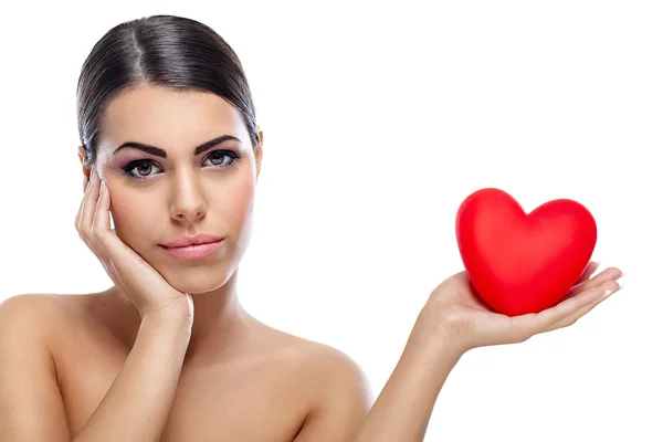 Pensive woman holding red heart — Stock Photo, Image