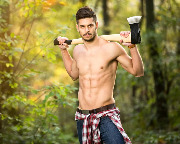 Sexy lumberjack in forest — Stock Photo, Image