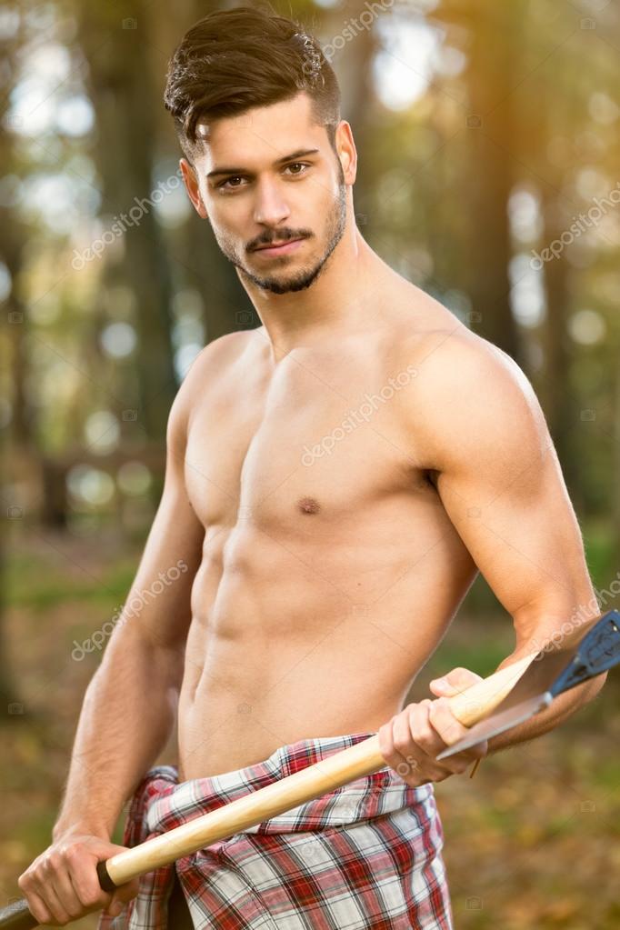Download - Sexy young lumberjack with axe - Stock Image. 