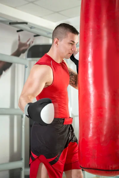 Muscular boxer punching bag — Stock Photo, Image