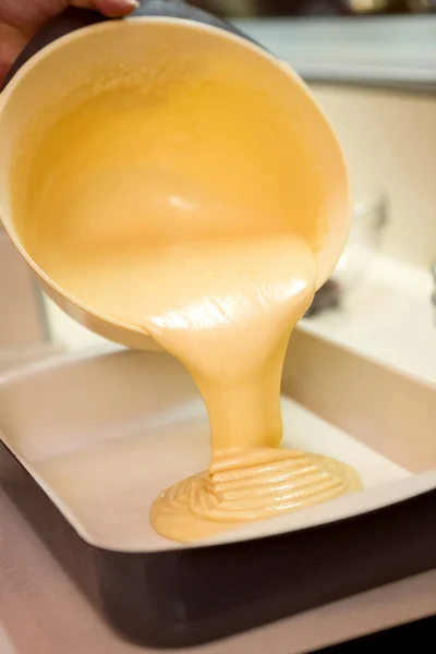 Cake mixture being poured — Stock Photo, Image