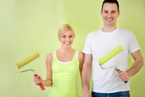 Happy love couple with equipment for painting — Stock Photo, Image