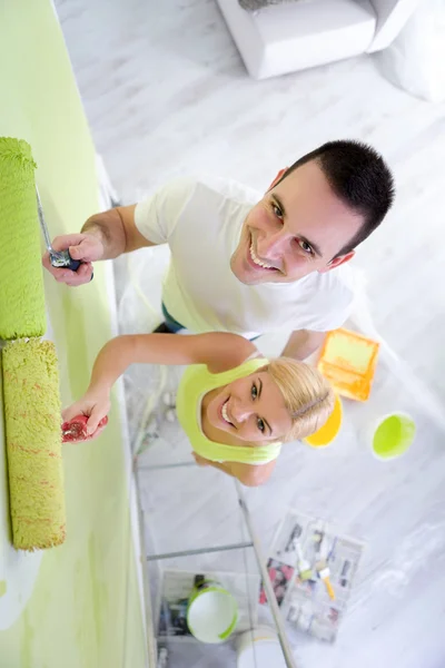 Renovation paint couple in new home painting wall — Stock Photo, Image