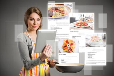 Women looking recipes over the internet clipart