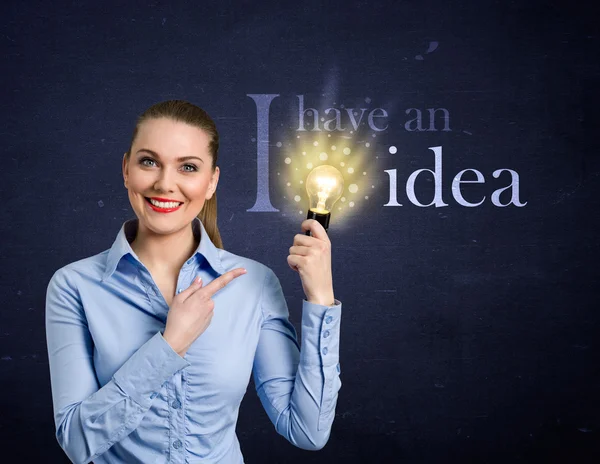 Woman holding bright bulb — Stock Photo, Image