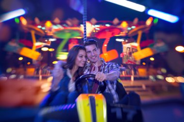 couple in bumper car - shoot with lensbaby clipart